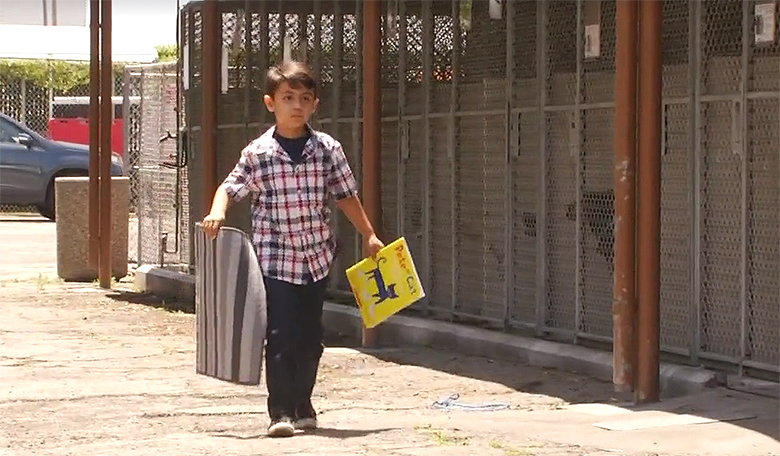 Boys with autism reads to pit bull 2