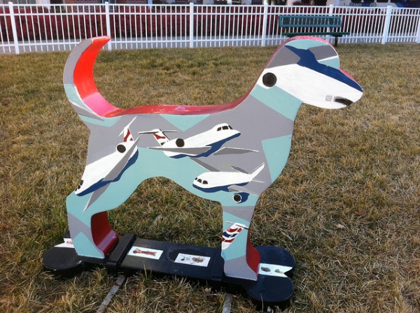 The wooden dog, inspired by the ark, is intricately painted with airplanes.