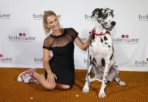 A woman posing with a dalmatian at the Bideawee Upcoming Ball to raise money.