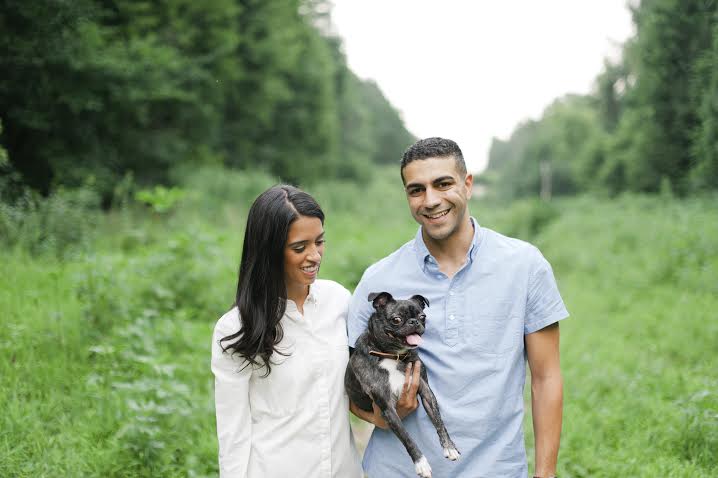 A couple enjoying a serene moment in a picturesque field alongside their beloved dog, capturing the perfect photo for the Dogs of Instagram community.