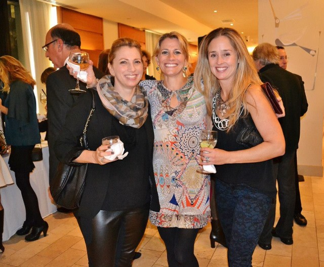 Three women posing for a photo at an event organized by The Good Dog Foundation.