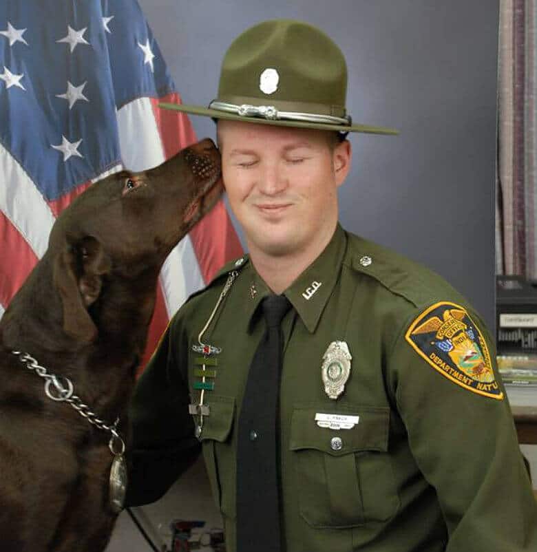 In Official Portrait, Dog Can’t Help But Express His Love for His Handler