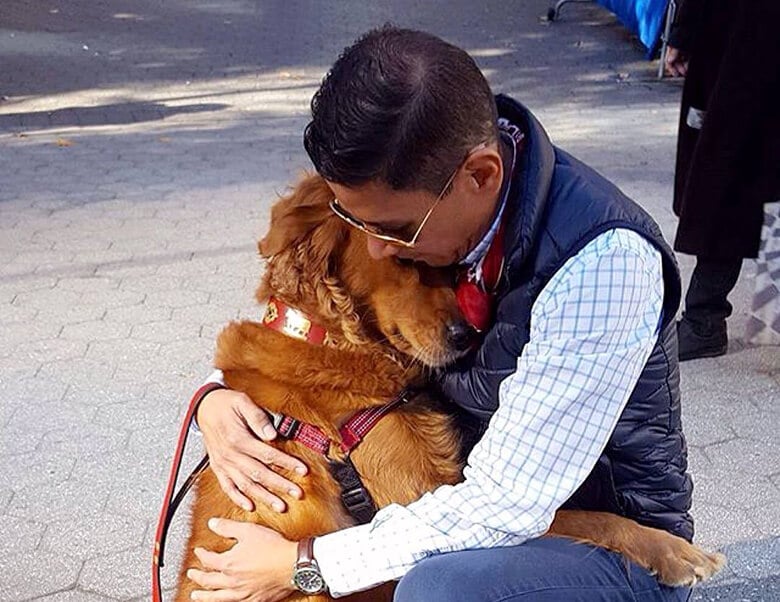 A man hugging a golden retriever in a heartwarming display of love and companionship.