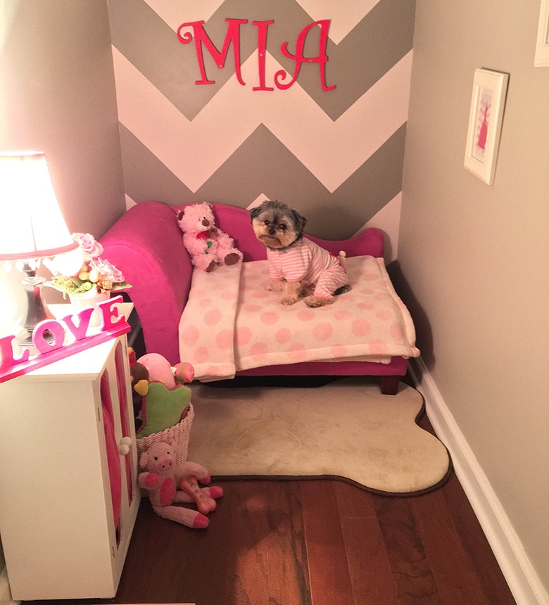 A girl's room with a pink bed and teddy bears, featuring a mini bedroom setup.