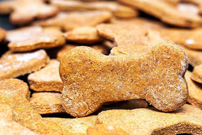 A pile of dog biscuits on a table, designed using a Dog Biscuit Recipe.