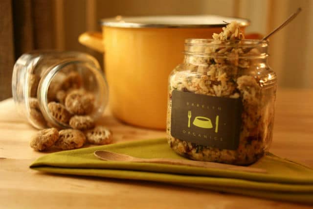 A jar of Barklyn Organics granola sitting on a wooden table.