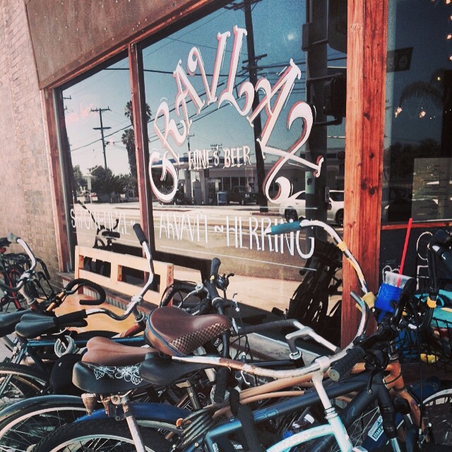 A group of bicycles parked in front of a store in Los Angeles.