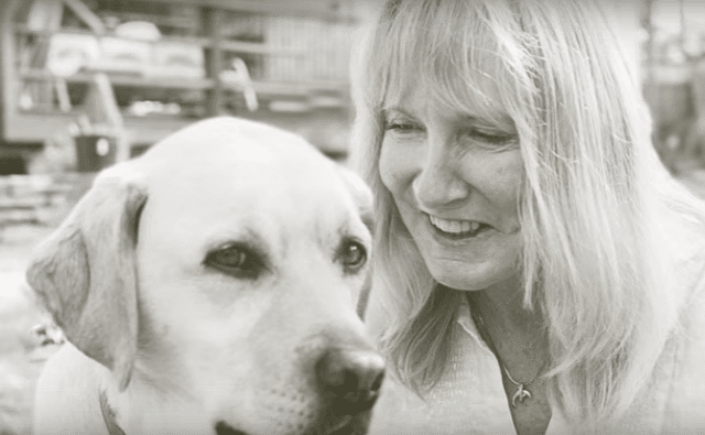 A poignant black and white photo capturing the bond between a woman and her loyal dog.