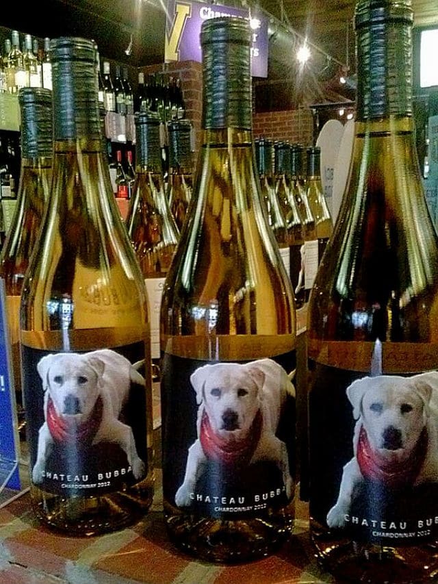 A vino-versity bottle of wine with a dog on it.