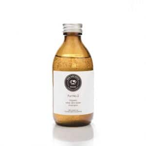 A bottle of facial cleanser designed for those allergic to dog allergies on a white background.