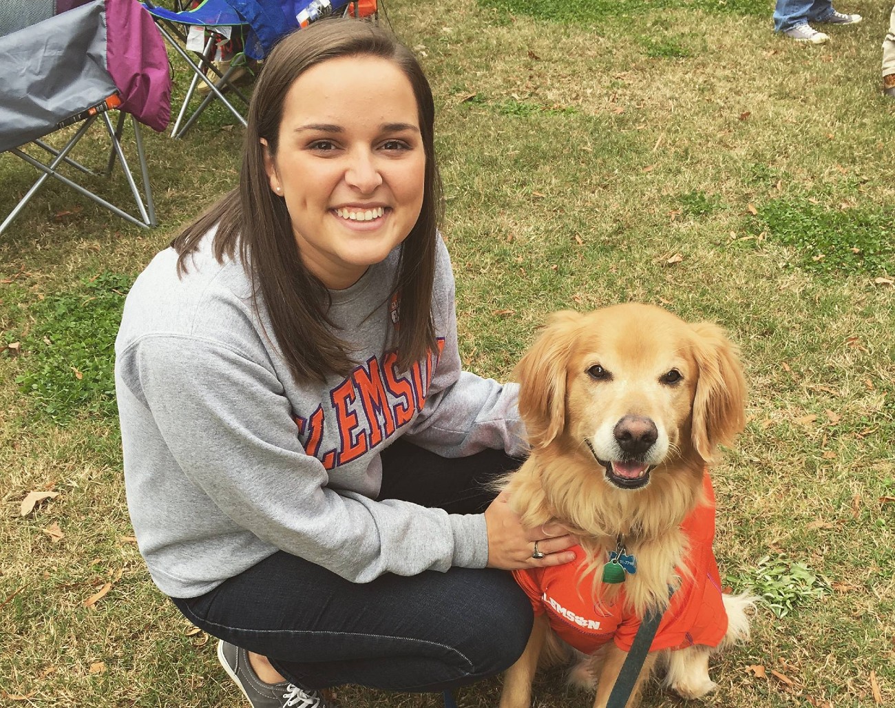 A woman's touching moment next to a golden retriever.