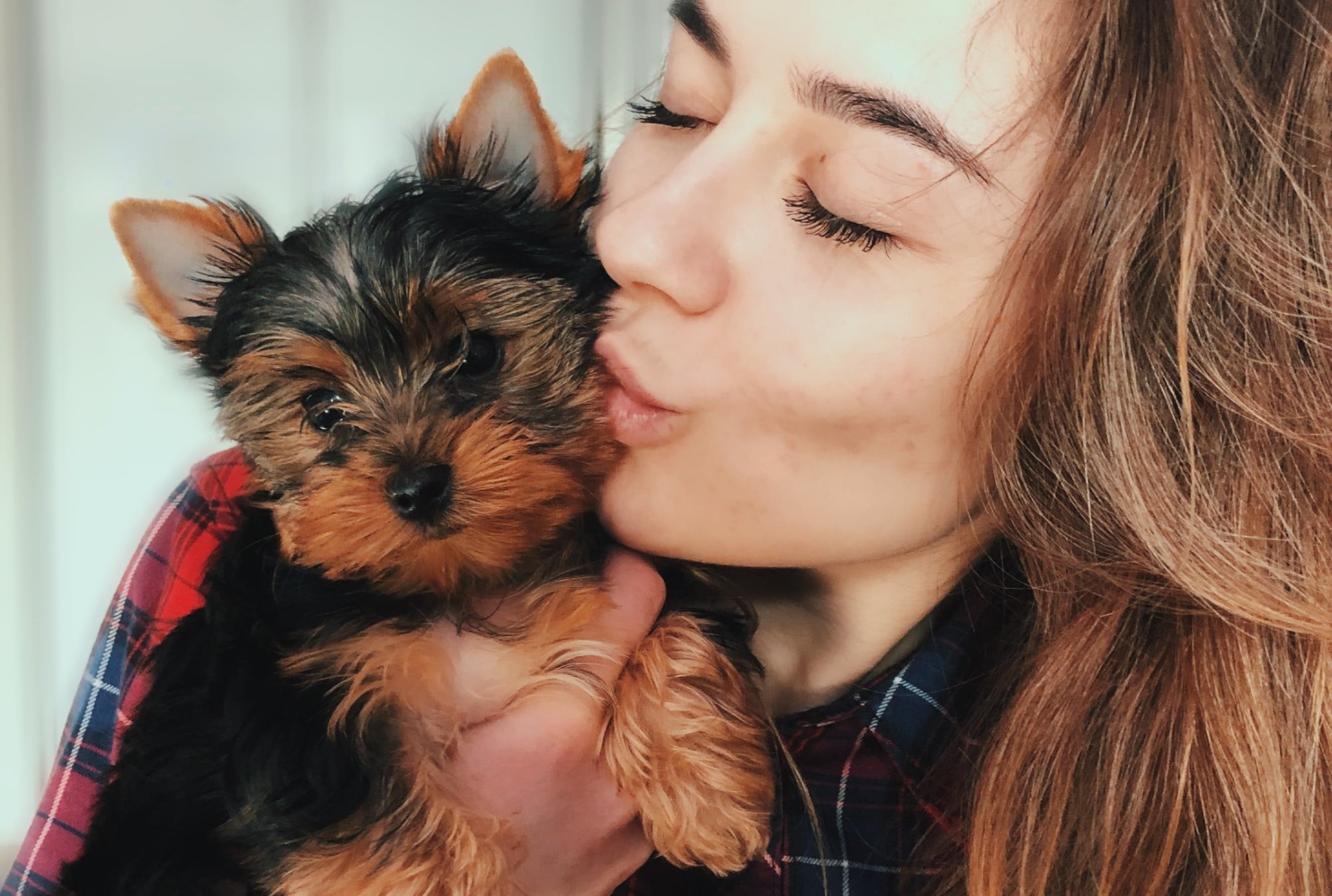 woman kissing dog