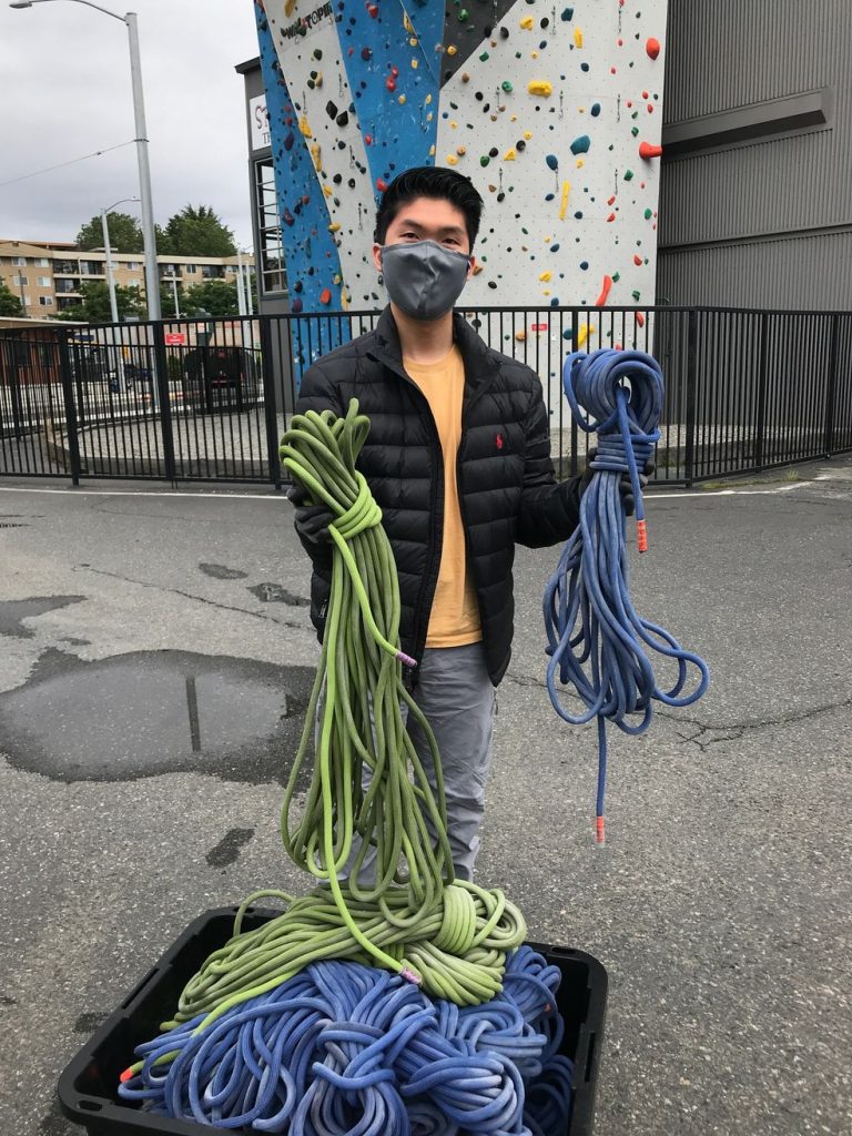 Alexander Tsao with old rock climbing ropes.