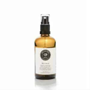 A bottle of dog sunscreen body oil on a white background.